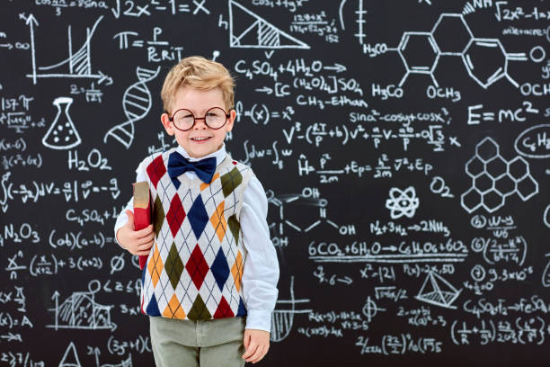 istock Smart boy in front of black board 826729626