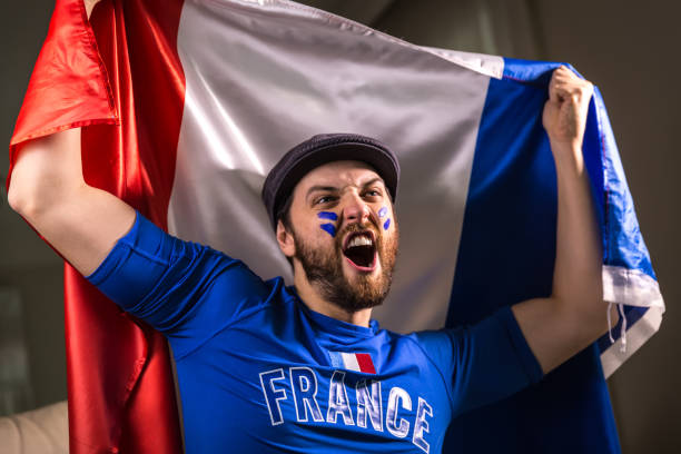 istock French fan holding the national flag 826729806