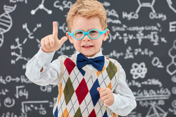 istock Smart boy in front of black board 826732554
