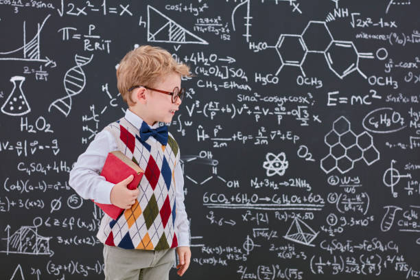 istock Smart boy in front of black board 826732682