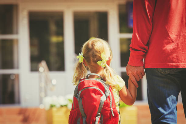 father and little daughter go to school or daycare father and little daughter go to school or daycare, education child care stock pictures, royalty-free photos & images
