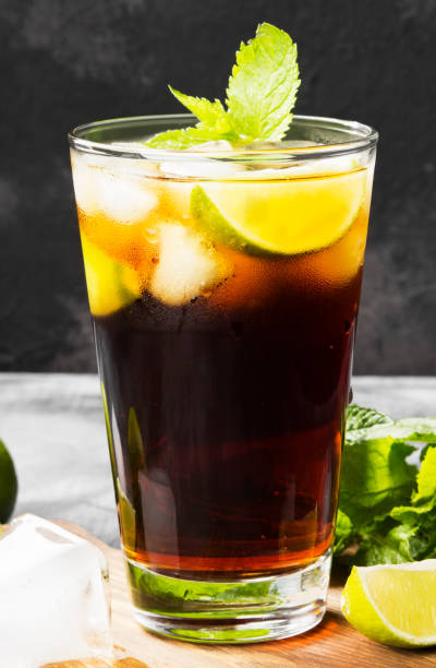 istock Cocktail Cuba Libre in a glass on a dark background 826740006