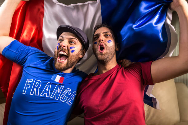 istock French fans holding the national flag 826740818