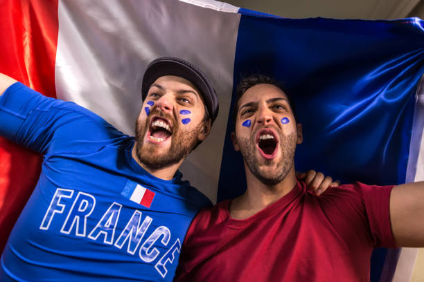istock French fans holding the national flag 826740820