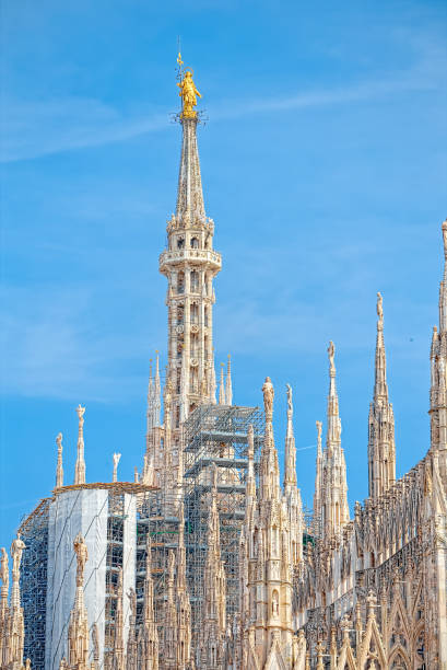 Details of the Milan Cathedral, the spiers and the Madonna Details of the Milan Cathedral, the spiers and the Madonna sentinel spire stock pictures, royalty-free photos & images