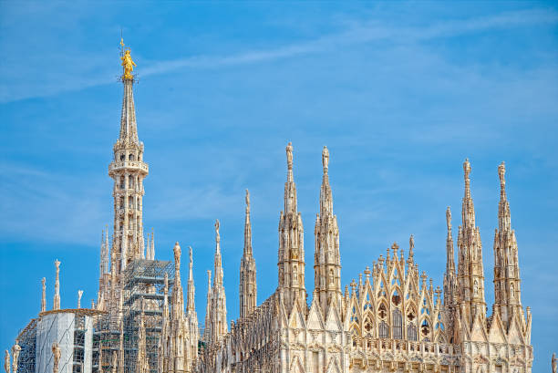 Details of the Milan Cathedral, the spiers and the Madonna Details of the Milan Cathedral, the spiers and the Madonna sentinel spire stock pictures, royalty-free photos & images