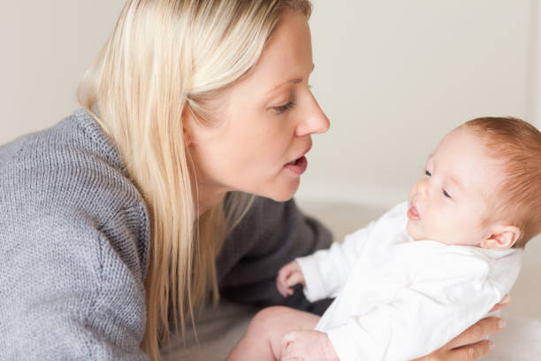 istock Side view of mother laying down her newborn 826751424