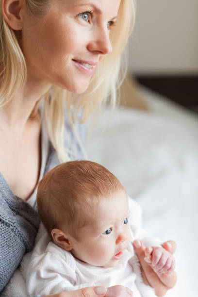 istock Mother hugging her newborn 826751560