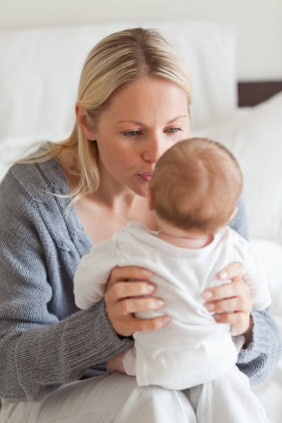 istock Baby sitting on mothers lap 826752178