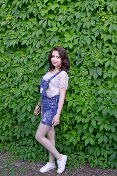 istock beautiful girl in jeans overalls 826753300