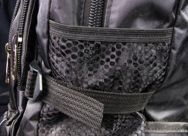 fittings and zips in the backpack closeup of buckles, clasps, zippers, pockets, fasteners, fittings and seams in the black backpack tineola stock pictures, royalty-free photos & images