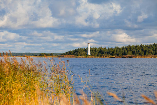 istock Baltic sea coast at sunset. Dramatic clouds, forest and small lighthouse. 826756664
