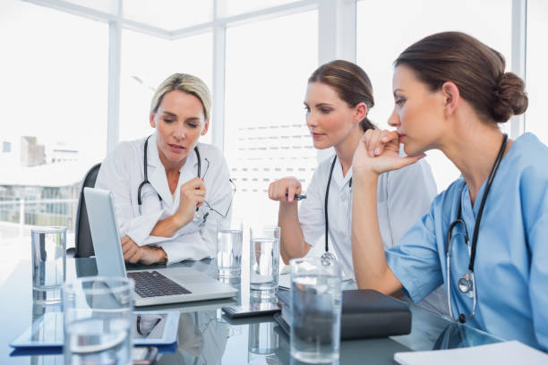 istock Three women doctors watching a laptop 826756918
