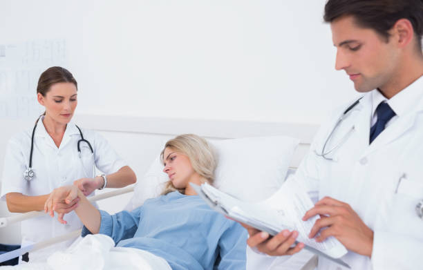 istock Doctor taking pulse of a patient 826760598