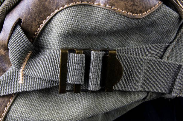 fittings and zips hand bag closeup of buckles, clasps, zippers, pockets, fasteners, fittings and seams on the hand bag of coarse cotton fabric tineola stock pictures, royalty-free photos & images