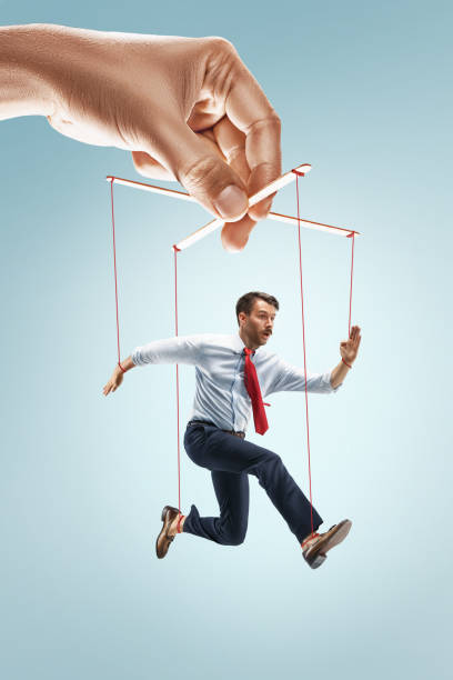 istock Businessman puppet on gray background 826763294