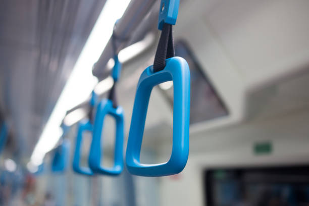 istock Blue plastic handles on ceiling rails for standing passenger, handle in underground railway or Mass Rapid Transit (MRT), use for people holding on the train or the bus prevent toppling selective focus 826763678