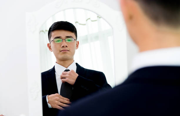 istock Young asian businessman adjusting necktie 826763948