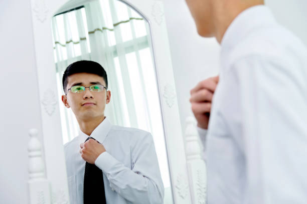 istock Young asian businessman adjusting necktie 826763956