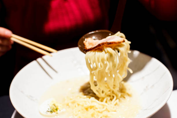 istock eating a bowl of ramen noodle soup 826767458