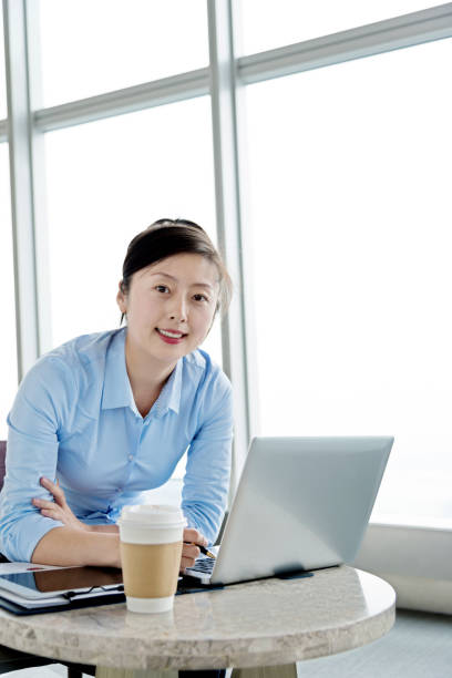 istock Attractive young businesswoman using laptop at a cafe 826785494