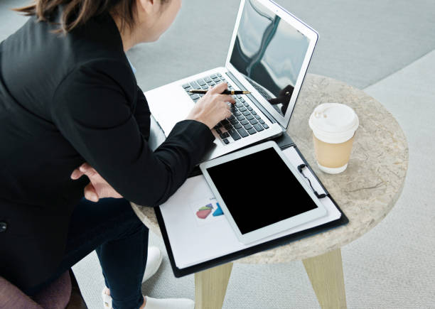 istock Young businesswoman using laptop at a cafe 826785594