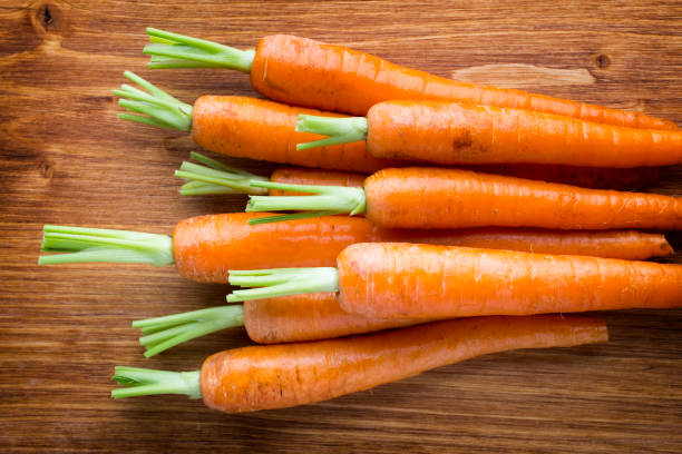 istock Fresh carrots on the wooden background. 826788594
