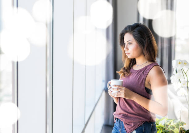 istock Hispanic woman drinking coffe at home 826788632