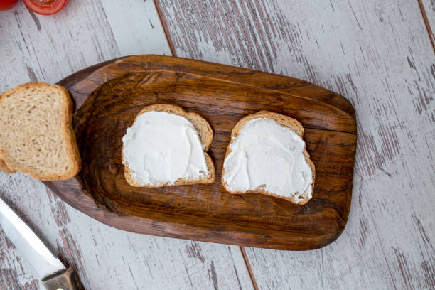 istock Butter and bread for breakfast, over rustic wooden background close up 826788666