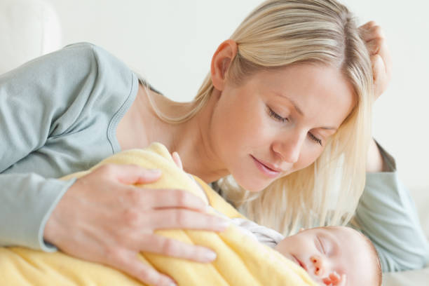 istock Mother relaxing next to her baby 826791524