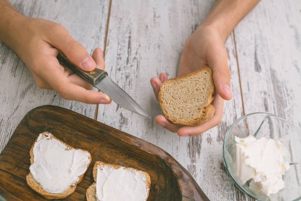 istock Butter and bread for breakfast, over rustic wooden background close up 826791736