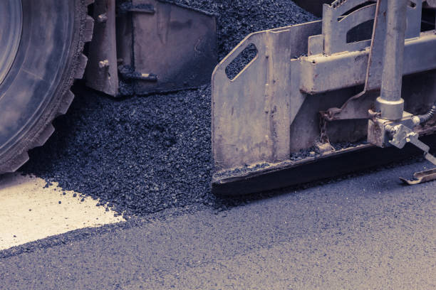 istock Paver makes the new asphalt on the road 826792504