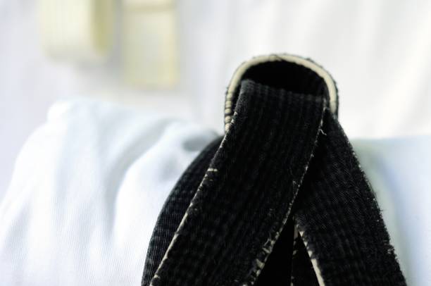 istock black belt martial arts on white background 826792818