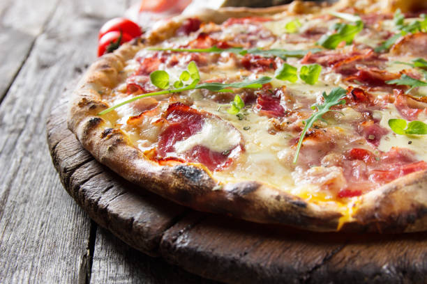 istock Pizza on the rustic wooden table 826795560