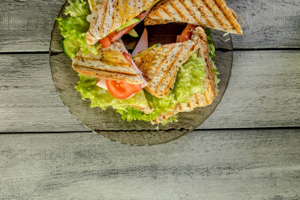 istock Panini sandwich with ham, tomato and lettuce. 826798790
