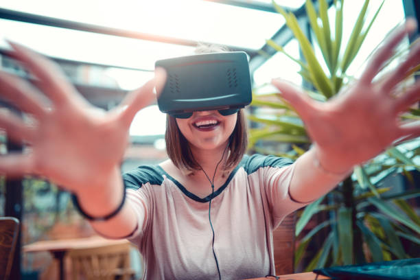 istock Young Woman Having Fun with Virtual Reality Simulator and Gesturing 826799440