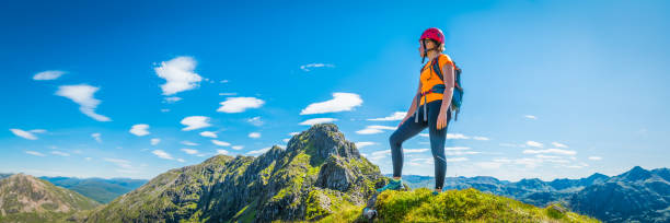 istock Female mountaineer on panoramic peak Aonach Eagach Glencoe Highlands Scotland 826802210