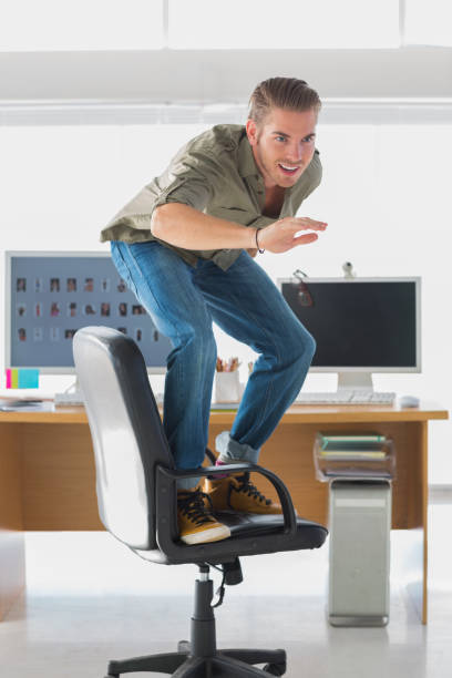 istock Handsome man surfing his office chair 826803538