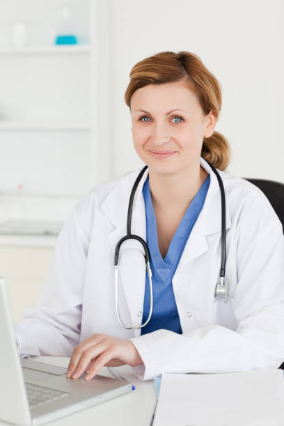 istock Smiling doctor working on her laptop 826807046
