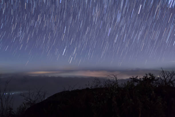 istock Long exposure image showing star trails over the mountain 826809278