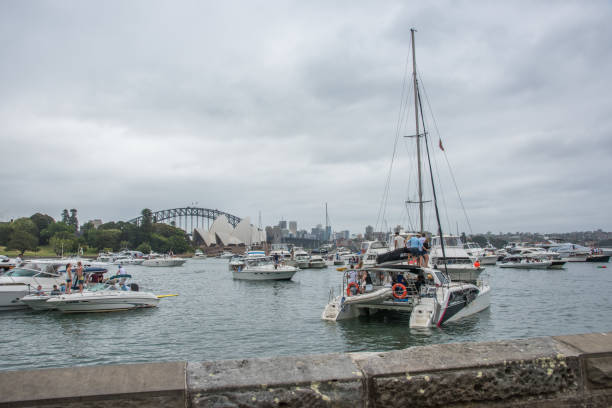 Sydney,NSW,Australia-November 19,2016: Nautical vessels with people in farm cove, with Opera House and Harbour Bridge view, for The Plot 2016 music festival in Sydney, Australia.