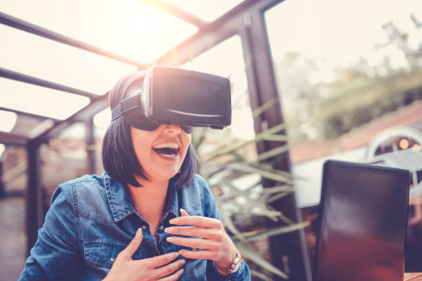 istock Young Woman Having Fun with Virtual Reality Simulator and Gesturing 826812642