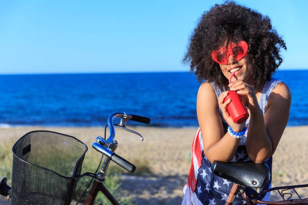 istock Woman with colorful sunglasses riding on sand 826815978