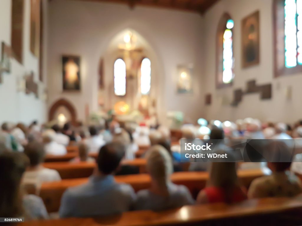 Blurred interior of the church Blurred photo of praying people in the church for abstract background Church Stock Photo