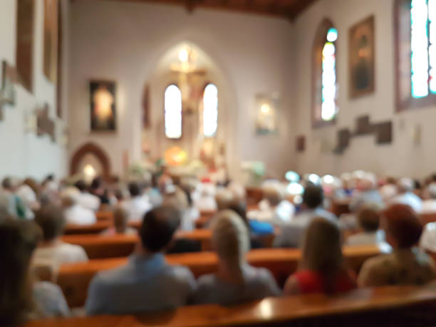 Blurred interior of the church Blurred photo of praying people in the church for abstract background chapel photos stock pictures, royalty-free photos & images