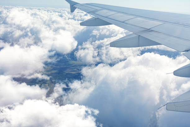 istock Clouds under the wing of an airplane 826827954