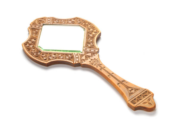 istock Ancient wooden hand mirror lies on a white background 826834054