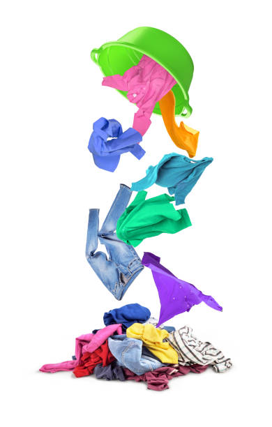 istock Plastic basin from which colorful clothes fall on a pile on a white background. 826837866