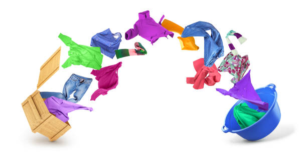 Clothes flying from a box in a bowl on a white background.