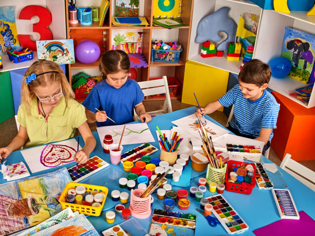 istock Small students girl painting in art school class. 826840148